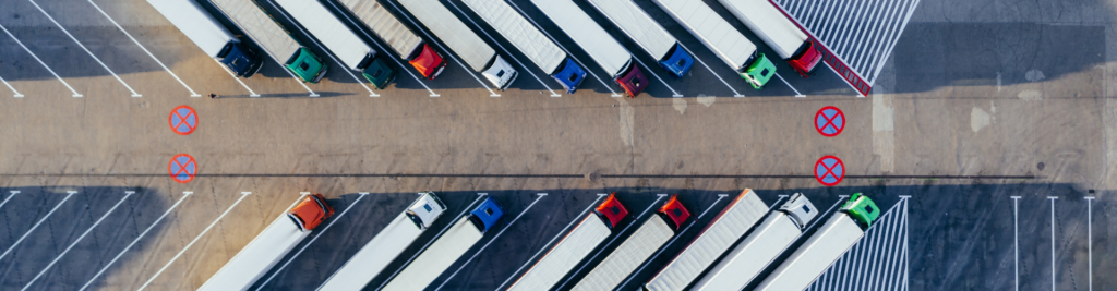 Multiple parked trucks and trailers seen from above