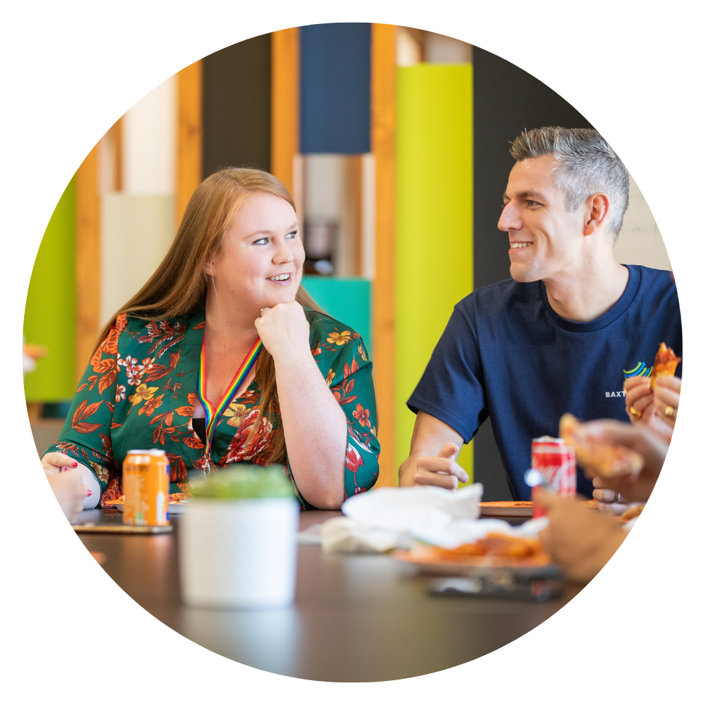 Two Baxter Freight Account Managers discussing work at a table